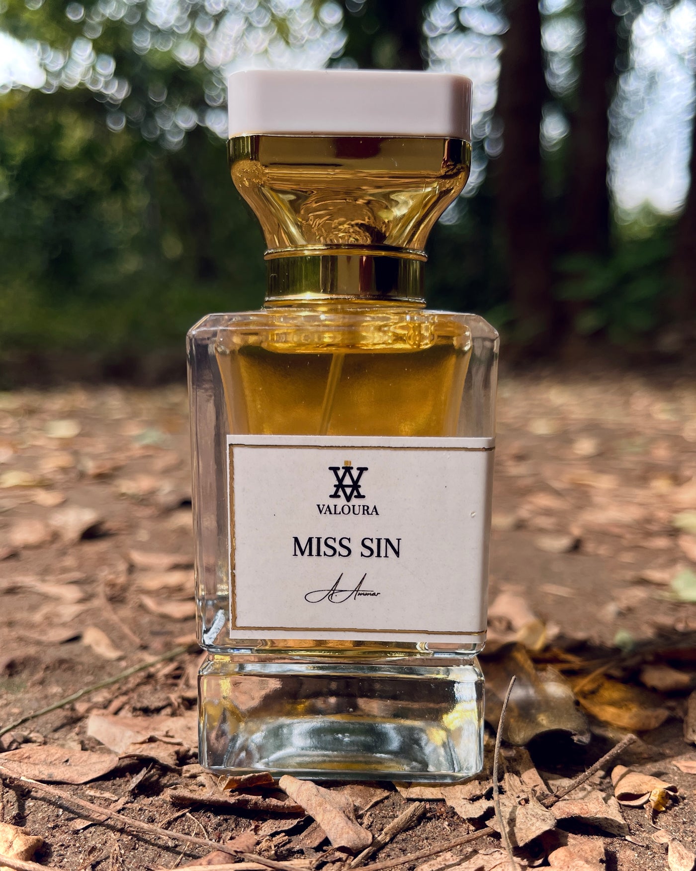 Perfume bottle labeled 'Miss Sin' by Valoura on a natural background