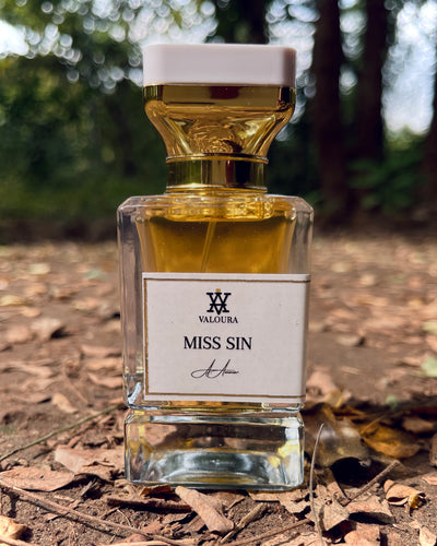Perfume bottle labeled 'Miss Sin' by Valoura on a natural background