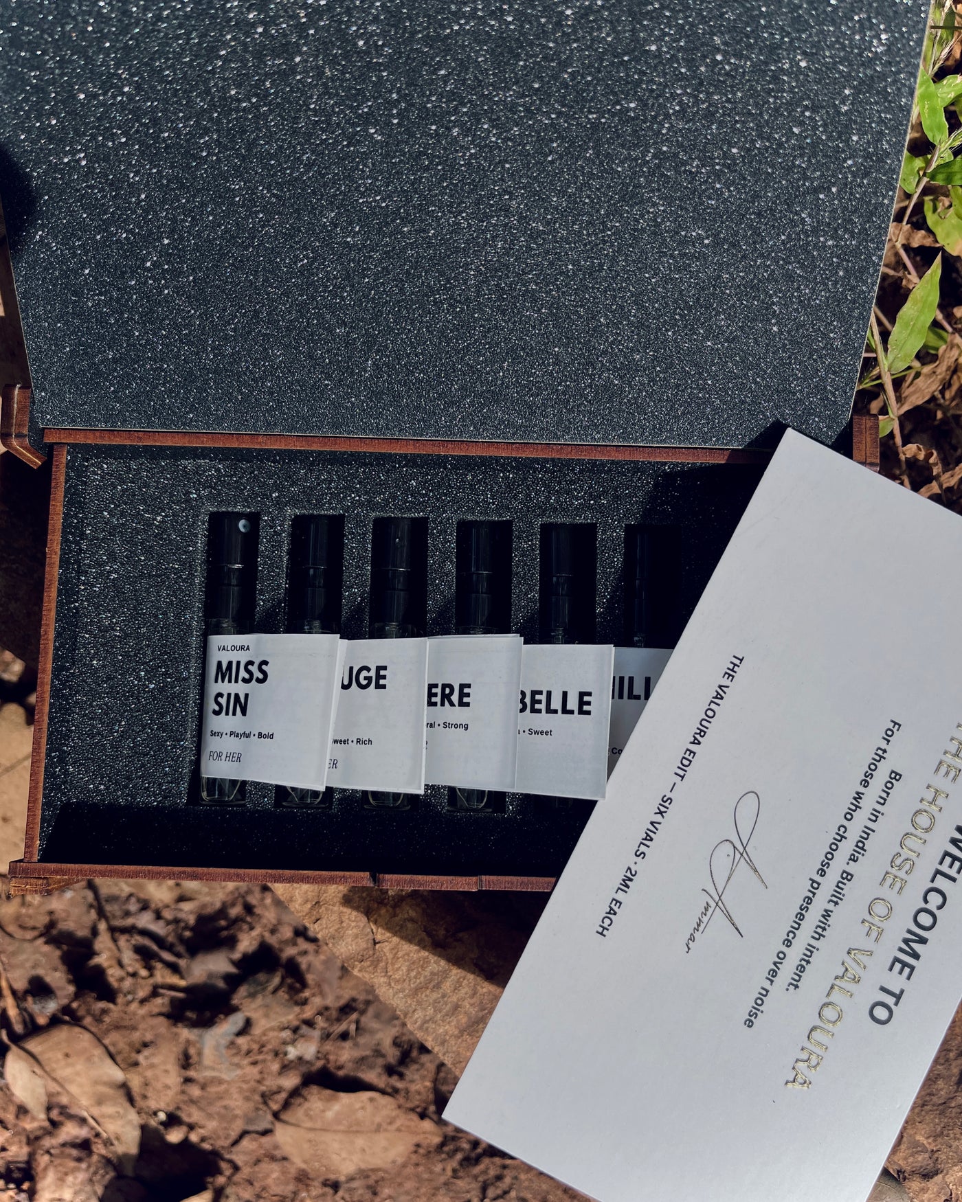 Discovery set for Her placed on wooden surface with leaves background