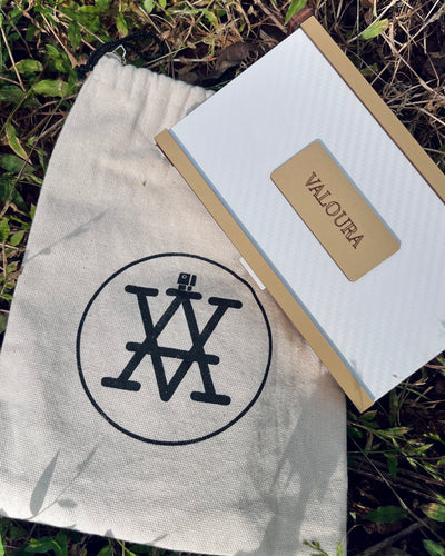 Valoura Edit For Her discovery vials arranged outdoors on beige fabric under daylight