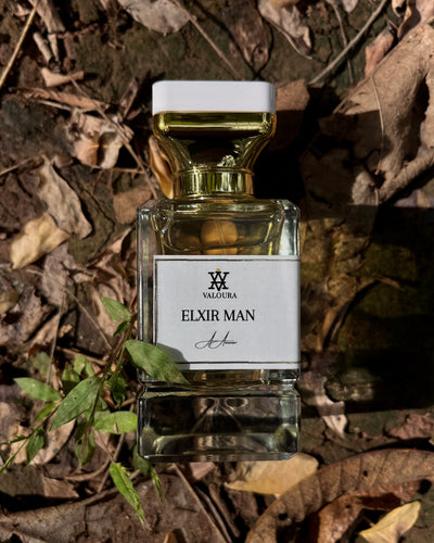 Perfume bottle labeled 'Elxir Man' by Valoura on a dried leafy background