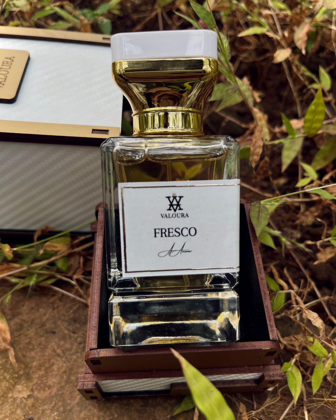 Perfume bottle labeled 'Fresco' on Valoura packaging box   by Valoura  on a natural background