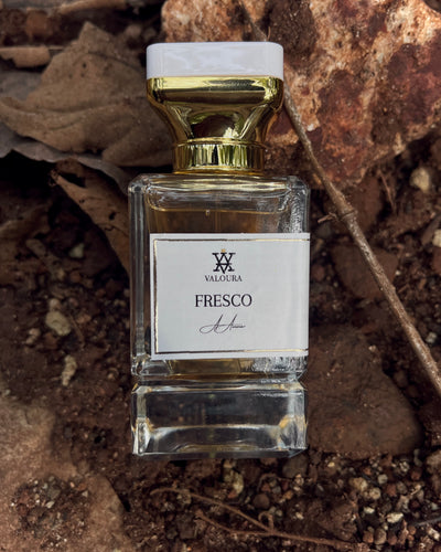Perfume bottle labeled 'Fresco' by Valoura on a natural stone dirt   background