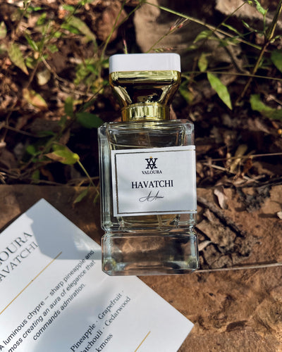 Perfume bottle with 'Havatchi' on a stone background with leaf 