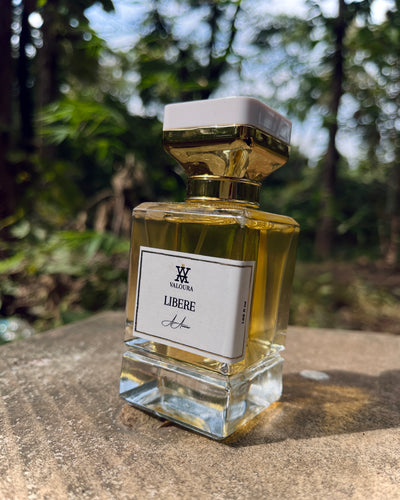 Perfume bottle labeled 'Libère' by Valhéria on a stone surface with a blurred natural background