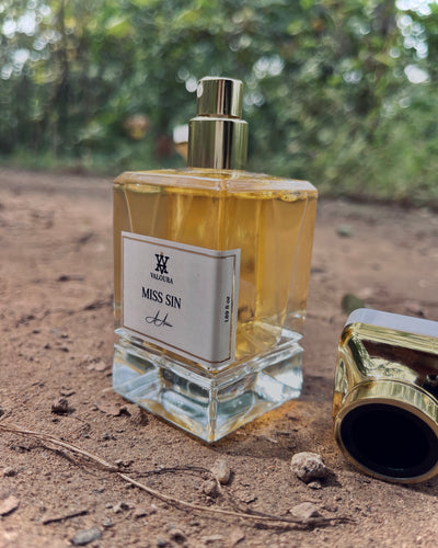 Perfume bottle labeled 'Miss Sin' on a natural background