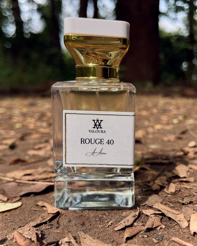 Artistic outdoor shot of Rouge 40 bottle emphasizing glass and shadow depth