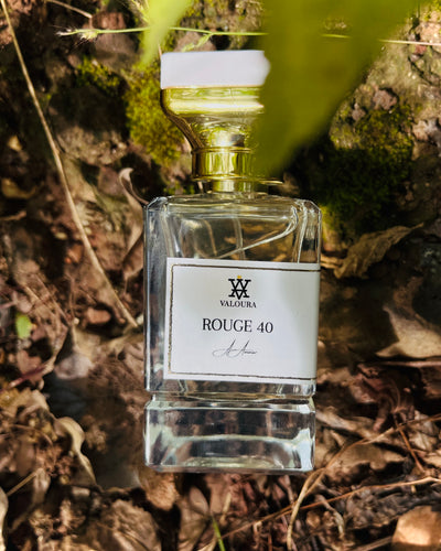 Rouge 40 bottle in sunlight surrounded by leaves and amber reflections