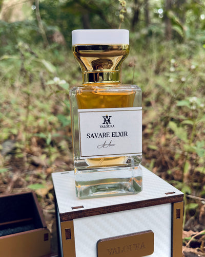 Valoura Savare Elixir perfume bottle on a wooden box with a forest background